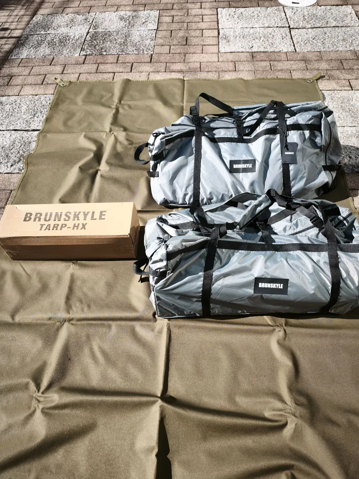 テント本体バッグ2つとTARP-HXの箱。グレーのバッグにBRUNSKYLEロゴ